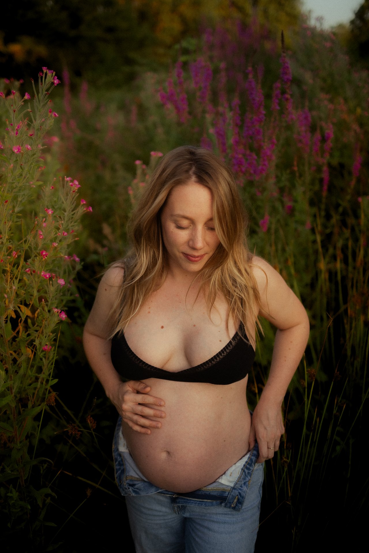 Femme enceinte dans un champ de fleurs violettes lors d'une seance grossesse en exterieur - Melissa Jai Photographe